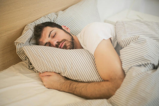 man sleeping well with Charlotte's Web Sleep Gummies
