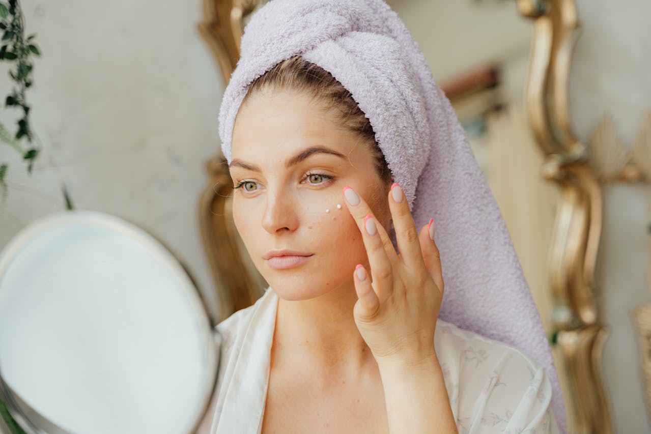 Woman applying CBD for acne